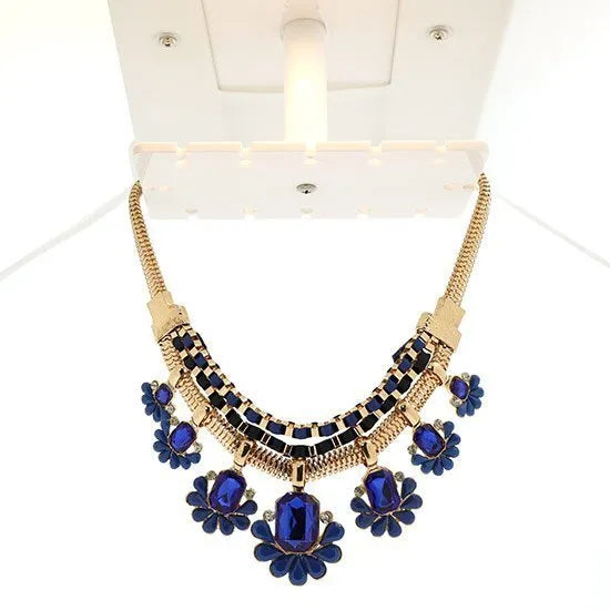 360 jewelry photography light box displaying a stunning gold and blue gemstone necklace on a white background.