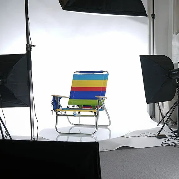 Colorful striped camping chair set up for 360 product photography shoot with studio lights.
