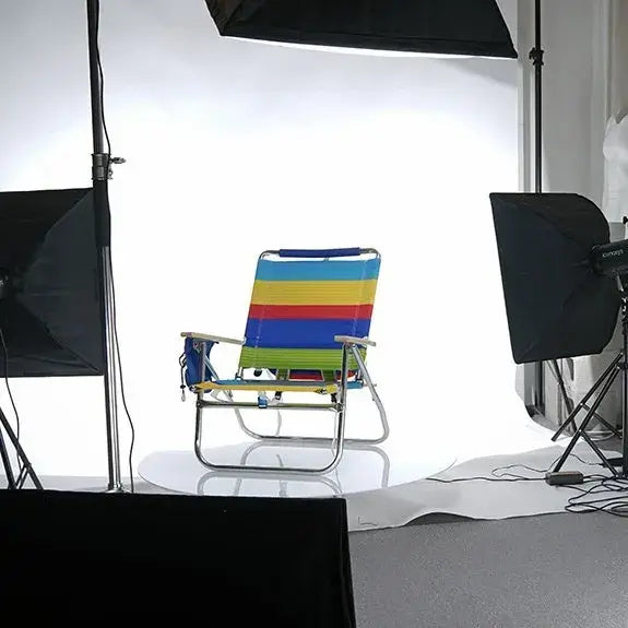 Colorful striped camping chair set up for 360 product photography shoot with studio lights.
